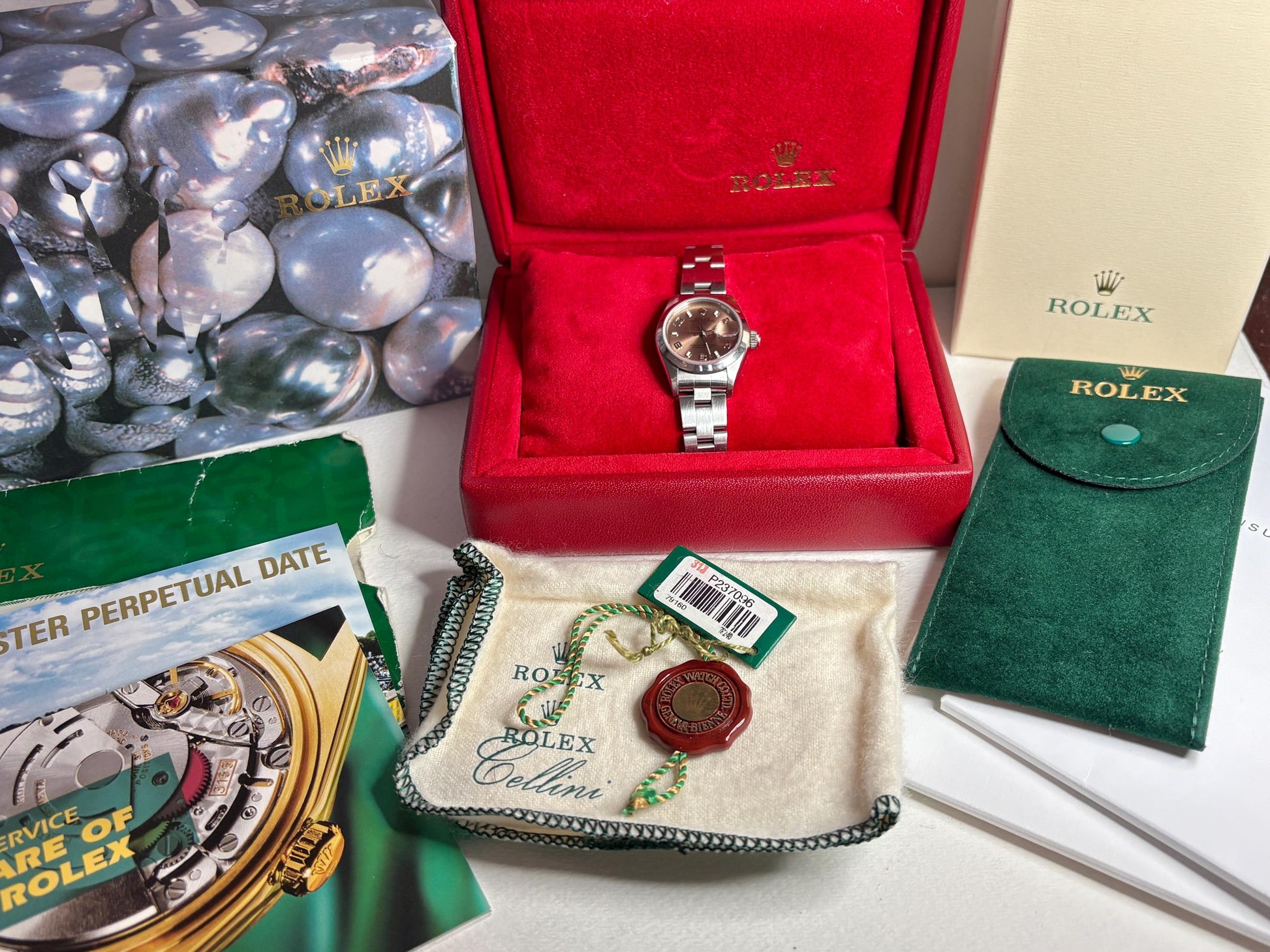 Rolex Women's Oyster Perpetual watch with rose dial, box, and papers.