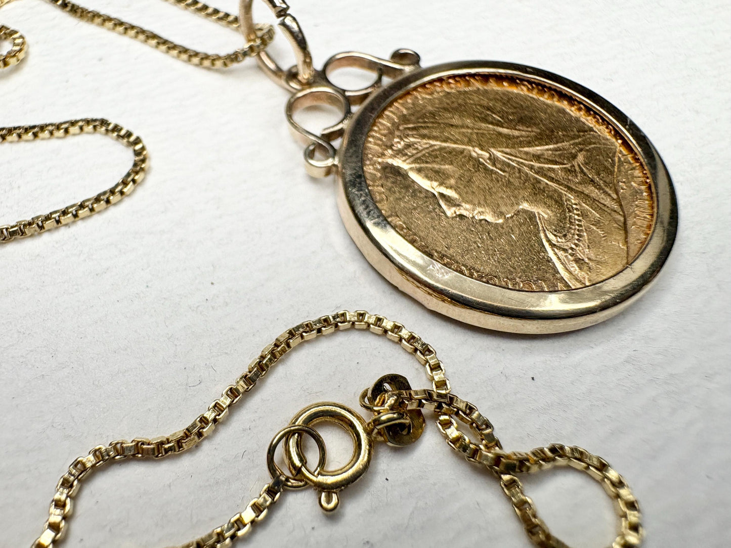 Gold coin pendant with Queen Victoria and a gold chain.