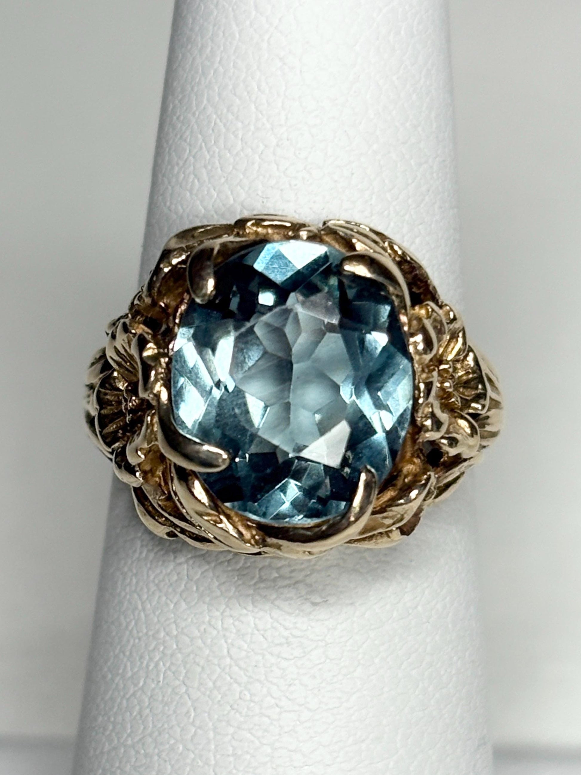Large mid-century 10k gold ring with a blueish synthetic spinel and floral details.