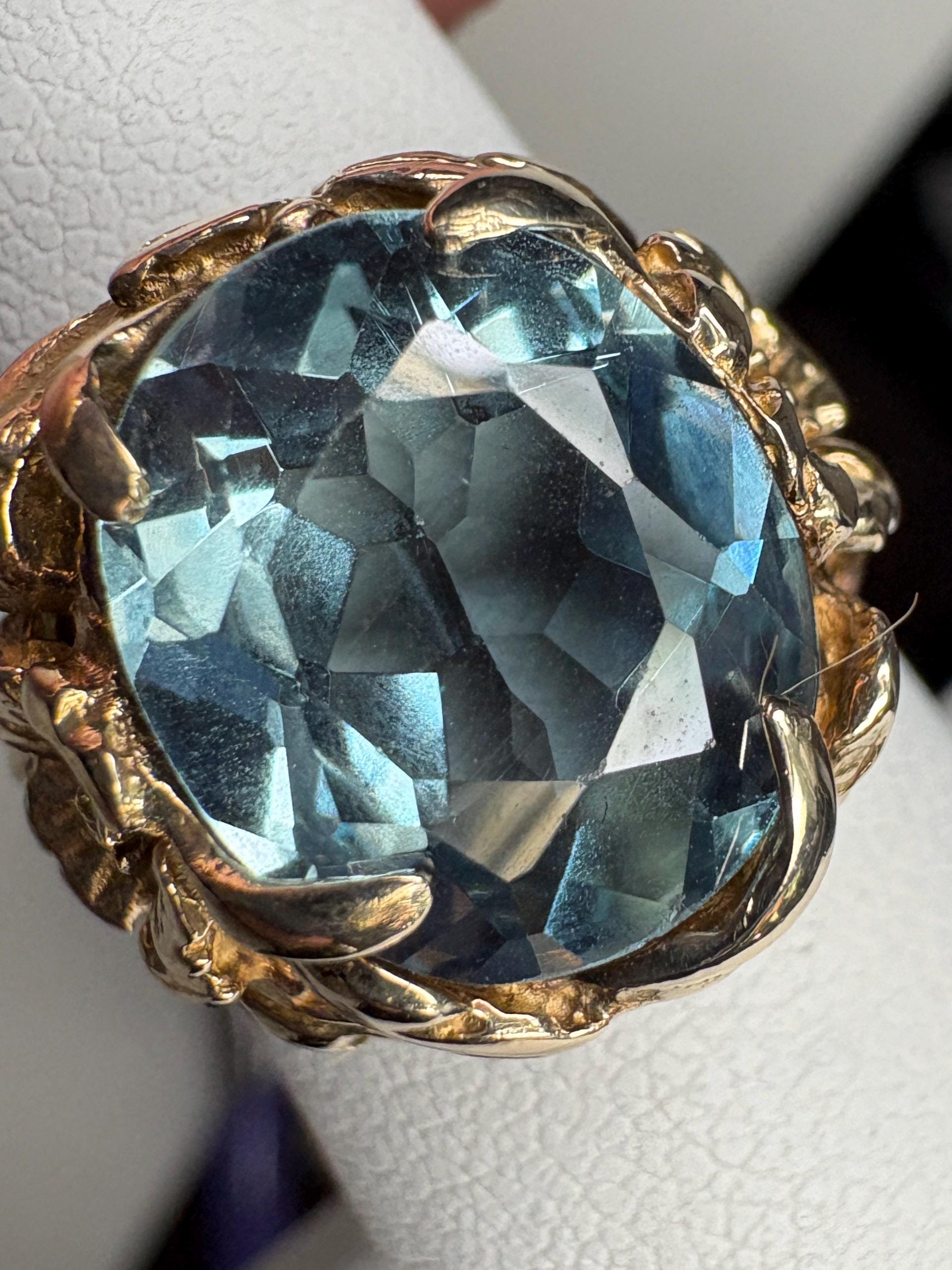 Large mid-century 10k gold ring with a blueish synthetic spinel and floral details.