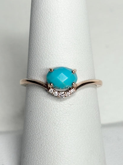 A rose gold ring with a checkerboard faceted turquoise and diamond accents.