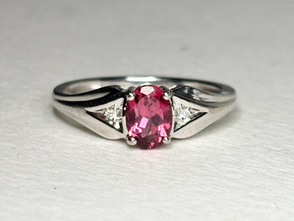 Oval pinkish red rubellite tourmaline and diamond ring in white gold.