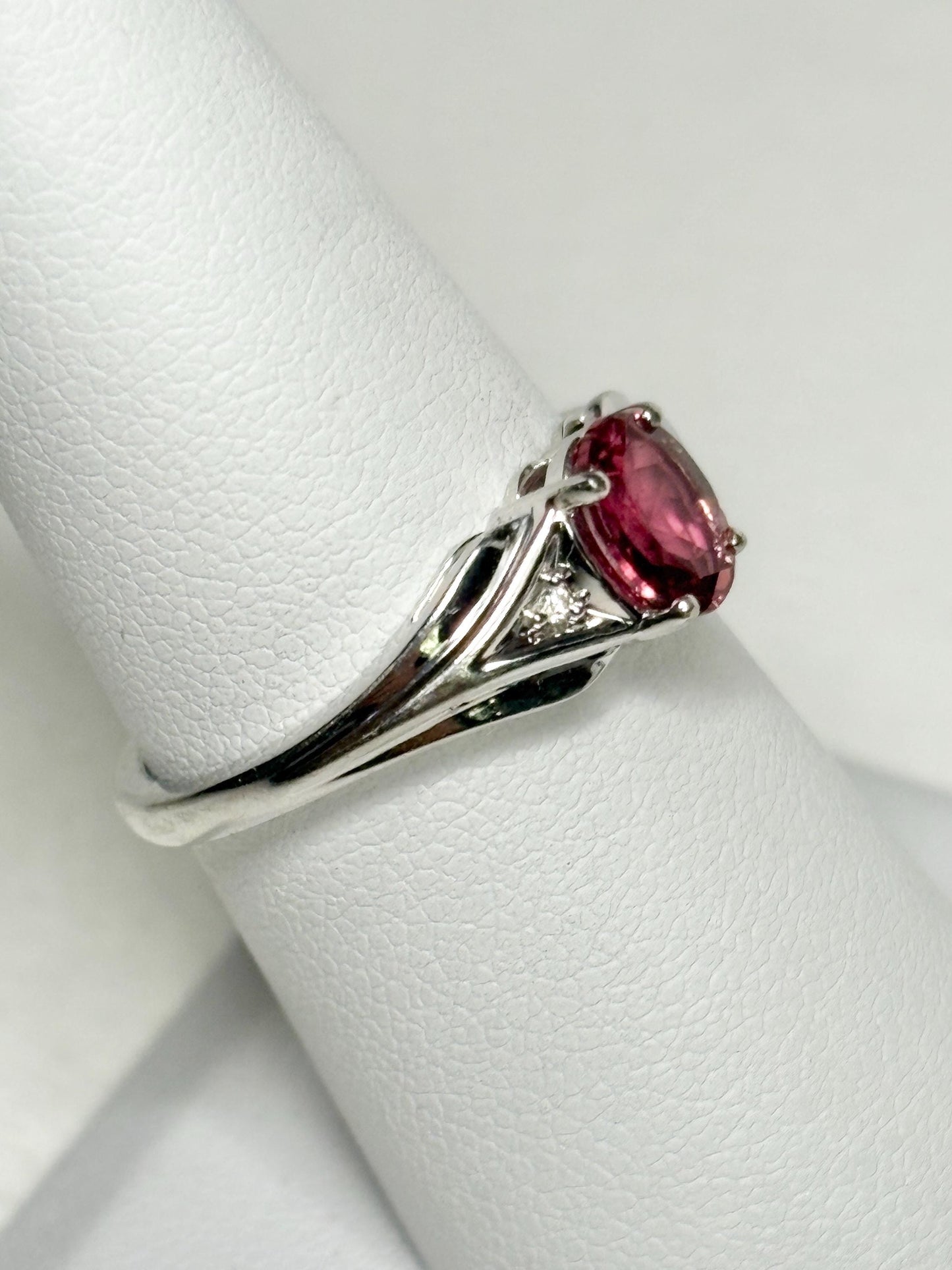 Oval pinkish red rubellite tourmaline and diamond ring in 10k white gold.