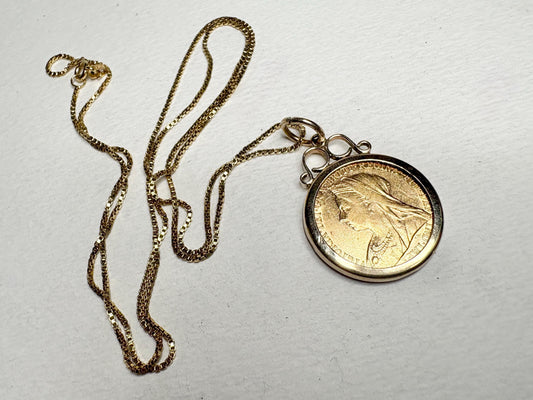 Gold coin pendant with veiled Queen Victoria on a gold chain.