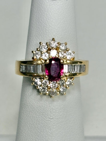 18k gold ring with oval ruby and surrounding diamonds and baguette diamonds.