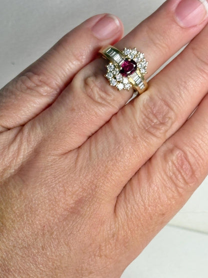 A ruby and diamond cocktail ring with baguette and round diamonds in 18k gold.