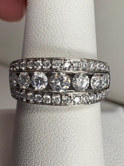 A 14k white gold anniversary band ring with channel and pave set diamonds.