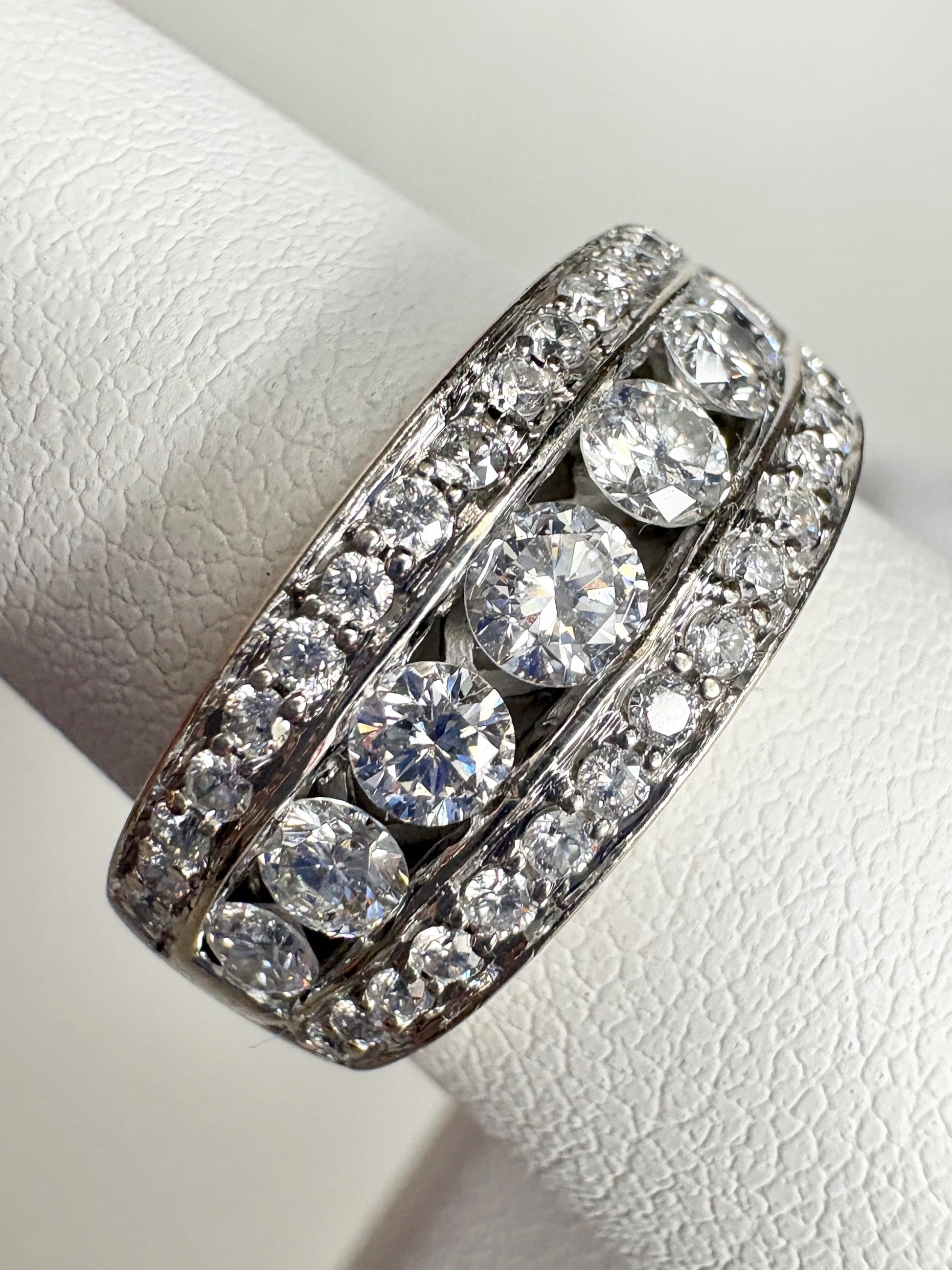 A channel and pave set diamond anniversary band ring in 14k white gold.