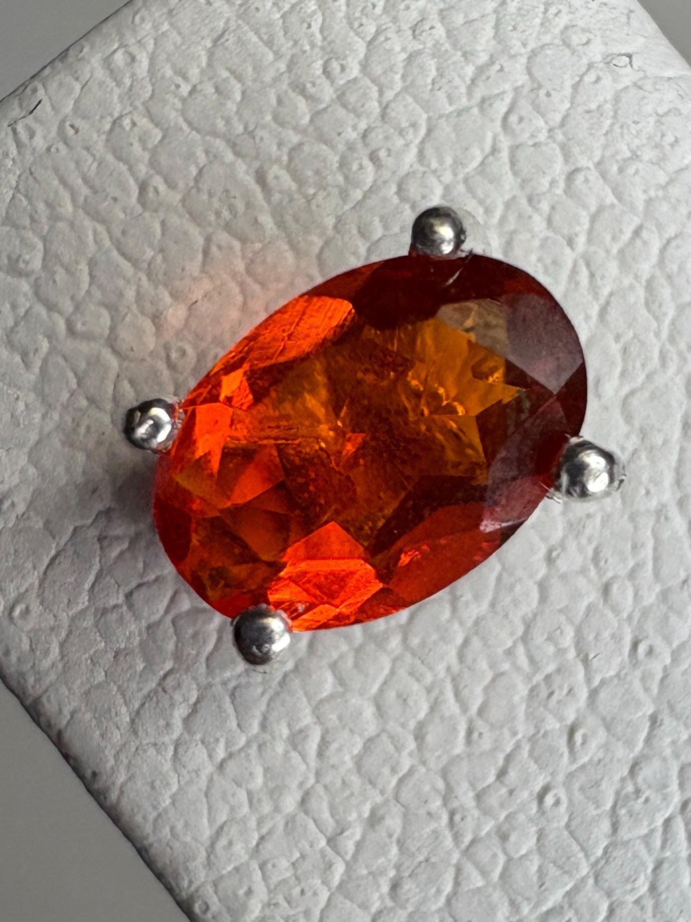 Oval Mexican fire opal solitaire stud earrings in sterling silver.