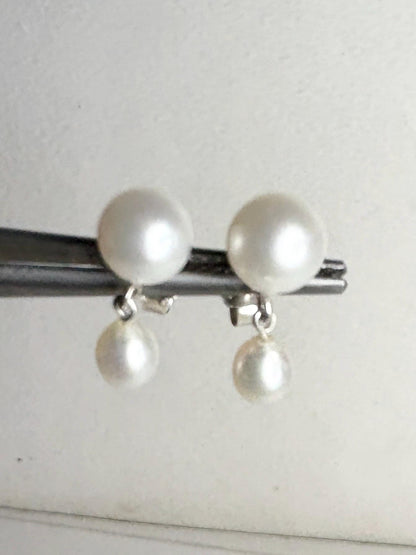 Sterling silver dangle earrings with two freshwater cultured pearls.