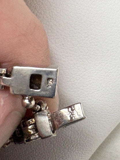 Sterling silver tennis bracelet with dark blue sapphires.