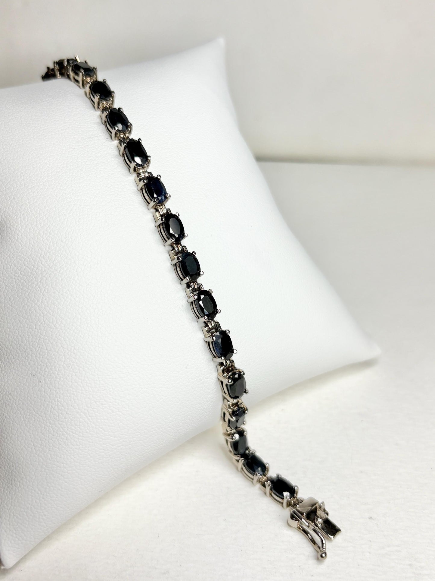 Oval dark blue sapphire tennis bracelet in stainless steel with sterling silver.