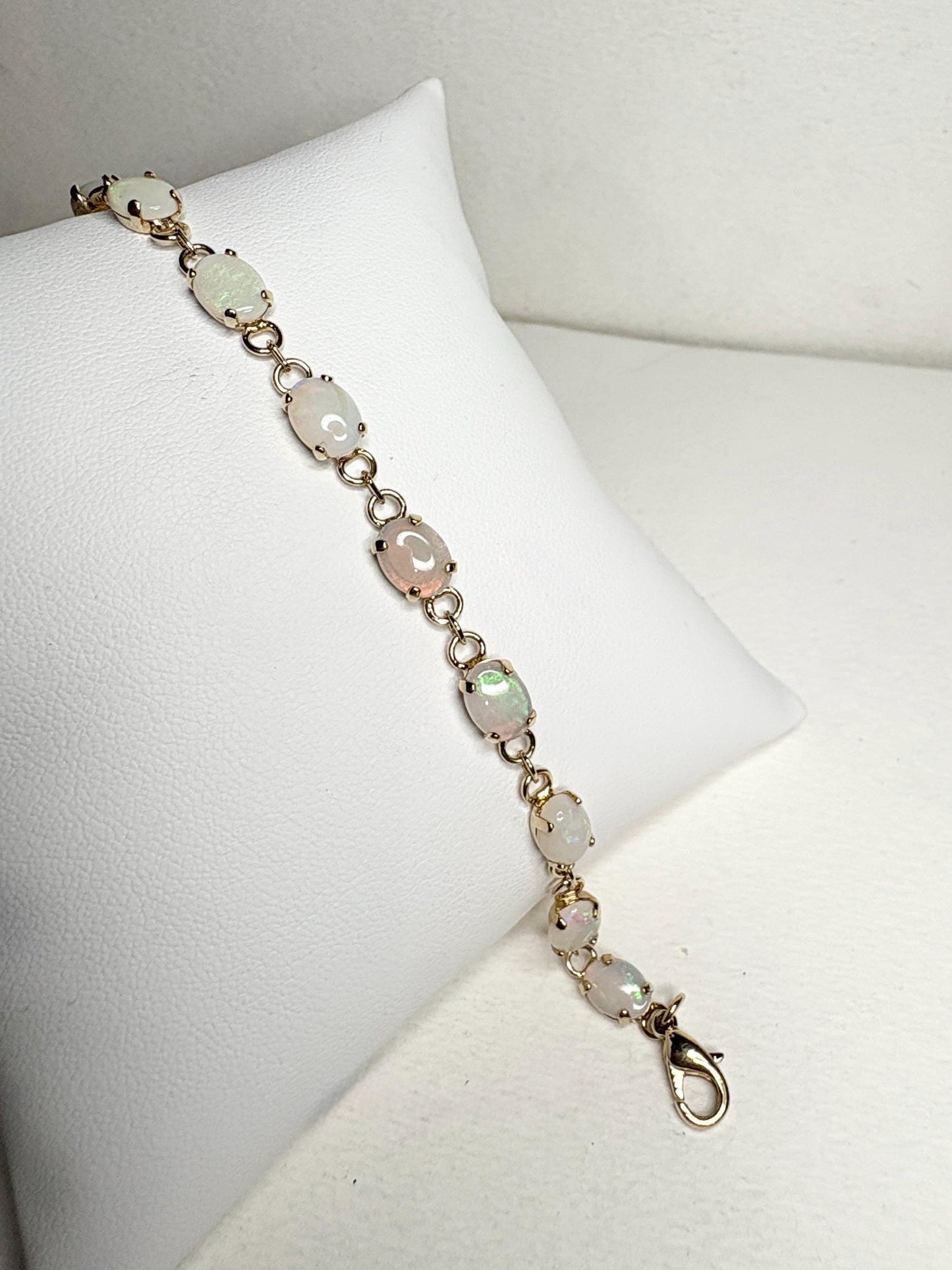 Gold plated tennis bracelet with 11 oval natural Australian opals.