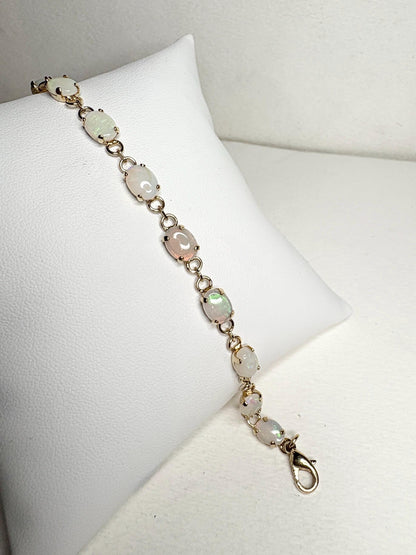 Gold plated tennis bracelet with 11 oval natural Australian opals.