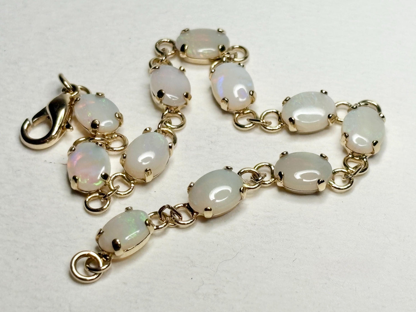 Gold plated bracelet with 11 oval natural opals.