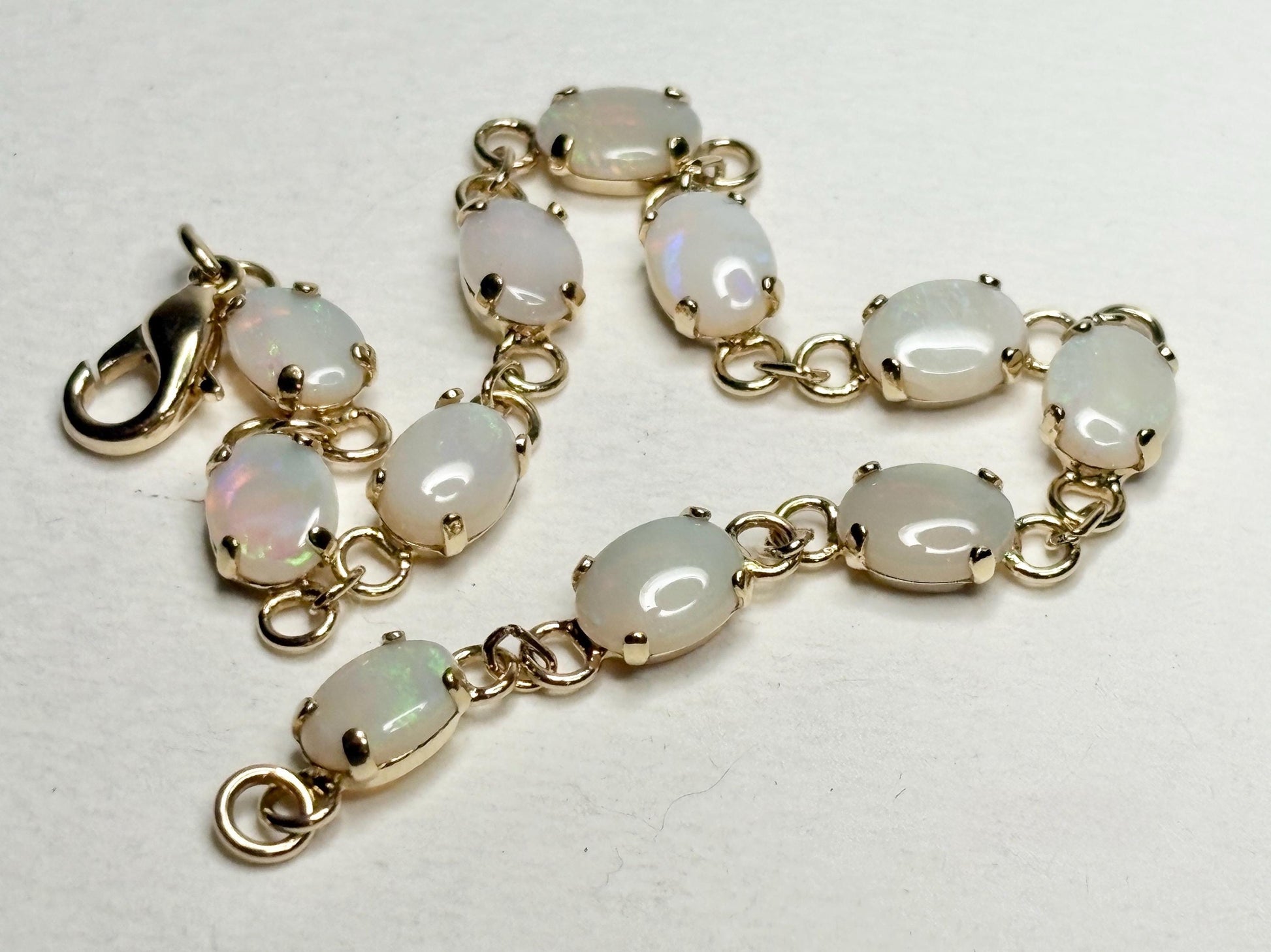 Gold plated bracelet with 11 oval natural opals.