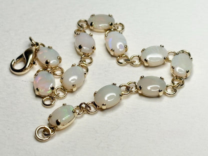 Gold plated bracelet with 11 oval natural opals.