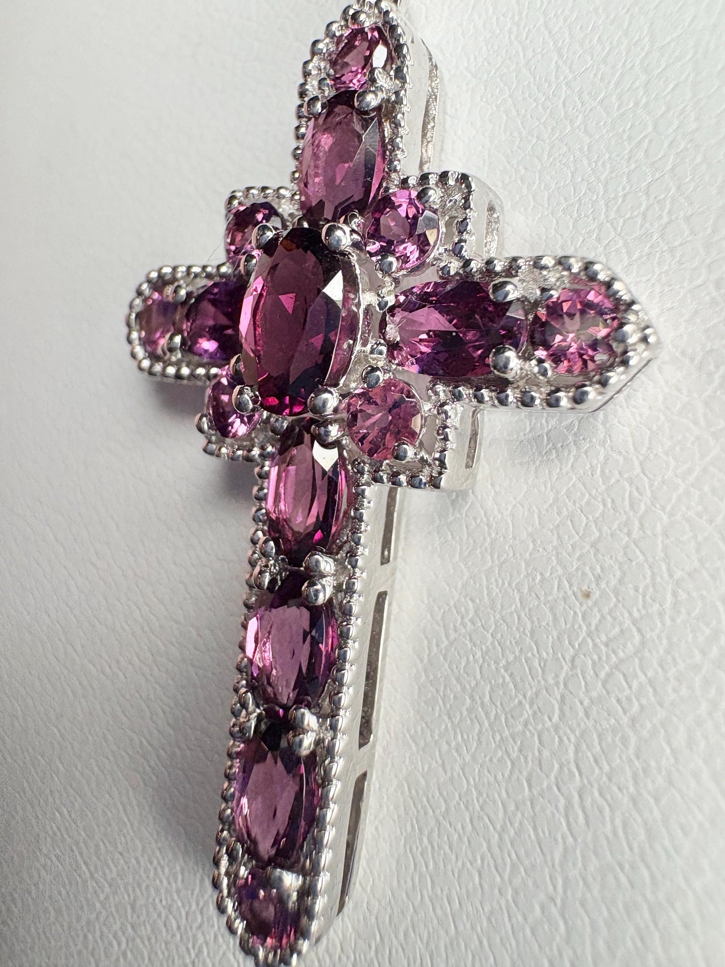 Sterling silver cross pendant with rhodolite garnets.