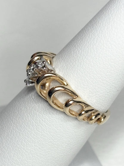 Vintage 14k gold ring with diamond accents and a ribbon loop design.