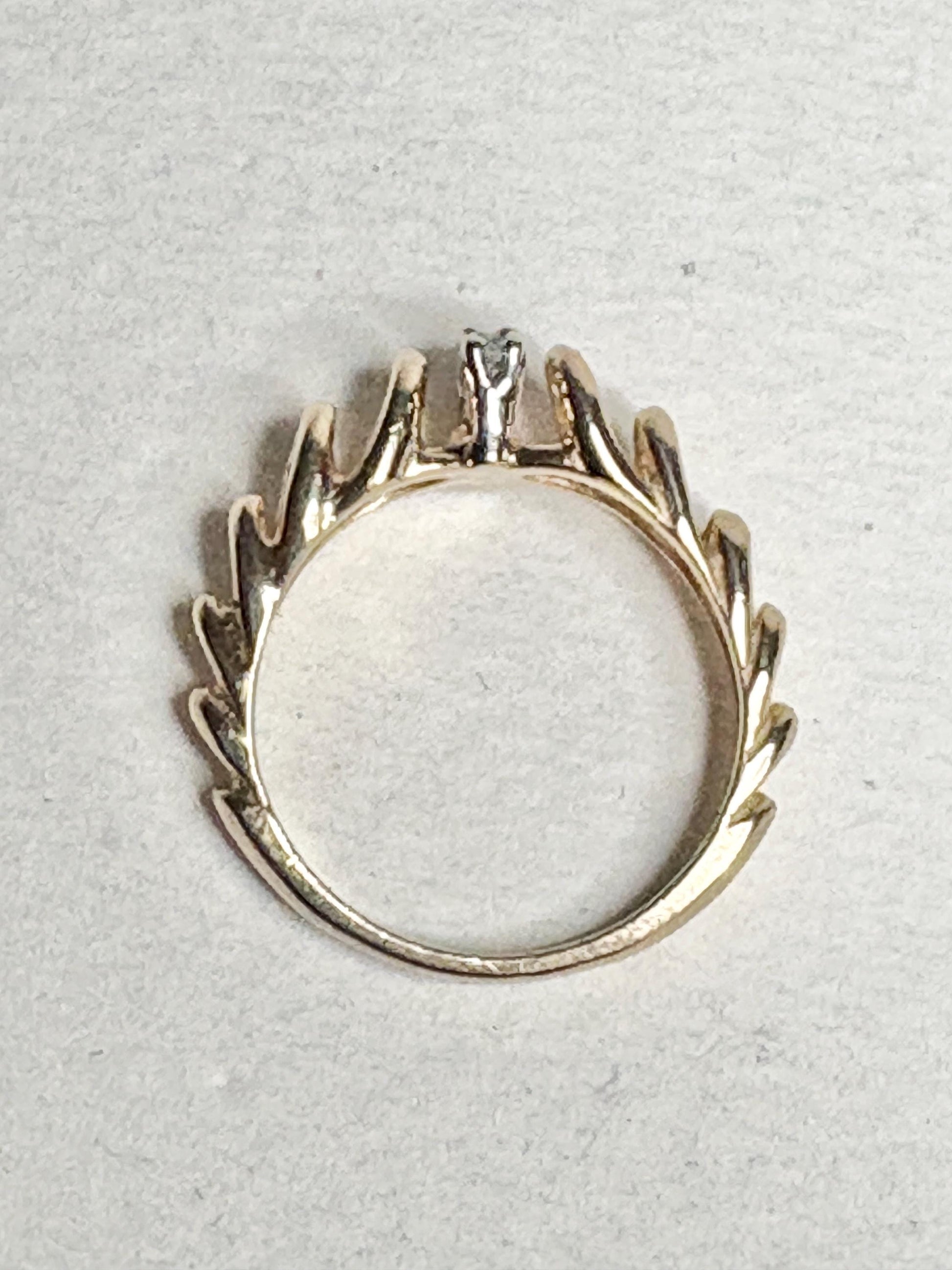 Vintage 14k gold ring with diamond accents and a ribbon loop design.