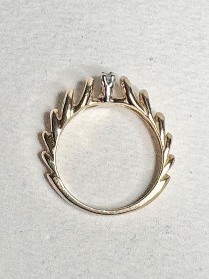 Vintage 14k gold ring with diamond accents and a ribbon loop design.