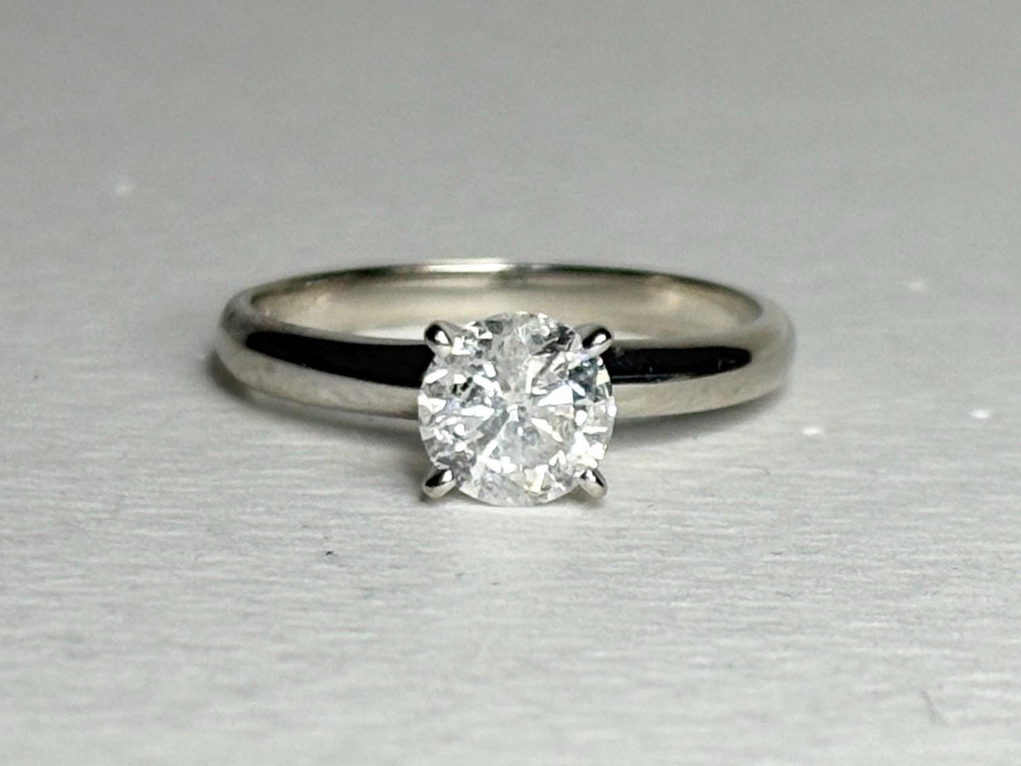A 1ct round solitaire diamond ring in a 10k white gold band.
