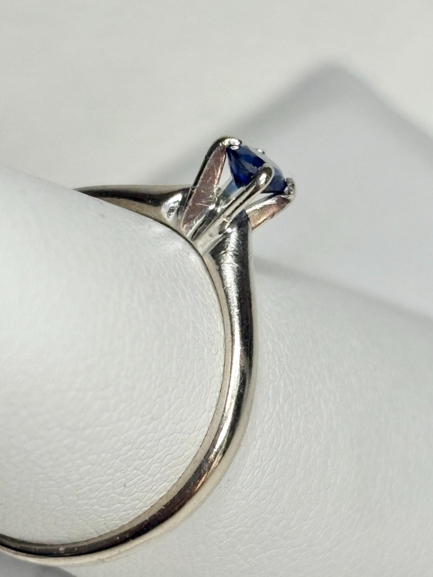 A vivid violetish blue sapphire solitaire ring in solid 14k white gold.
