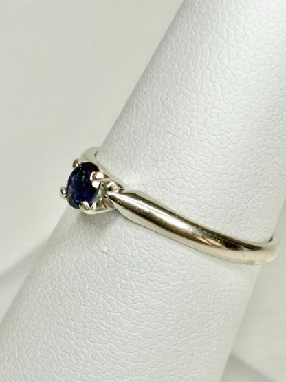A vivid violetish blue sapphire solitaire ring in solid 14k white gold.