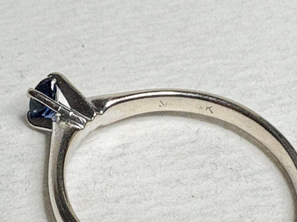 A vivid violetish blue sapphire solitaire ring in solid 14k white gold.