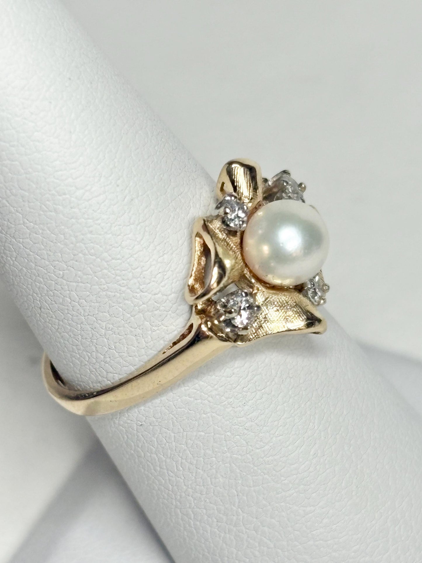 14k gold ring with Akoya pearl and diamonds in a bow design.