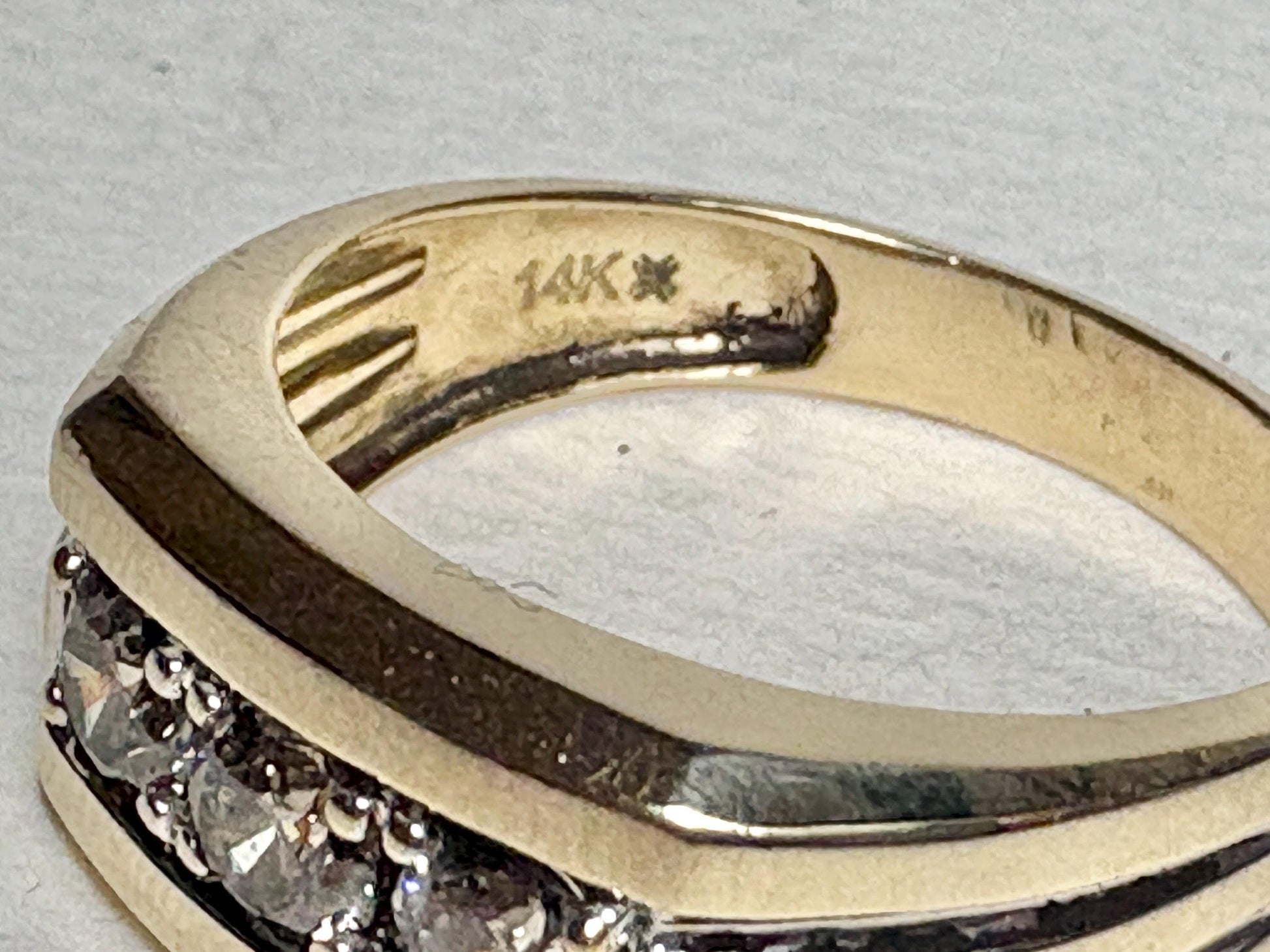 Men's 14k gold band ring with three champagne diamonds.