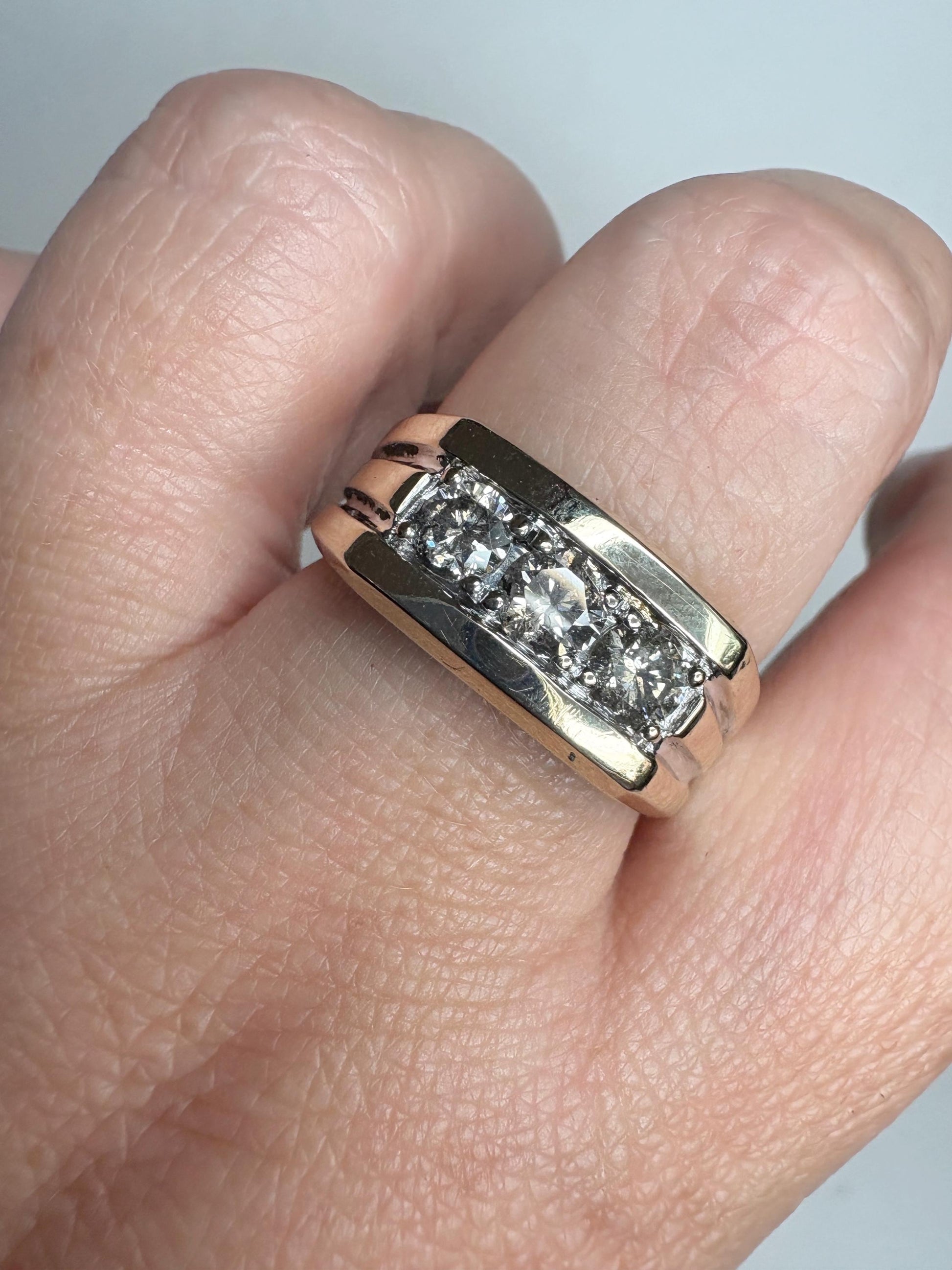 Men's 14k gold band ring with three champagne diamonds.