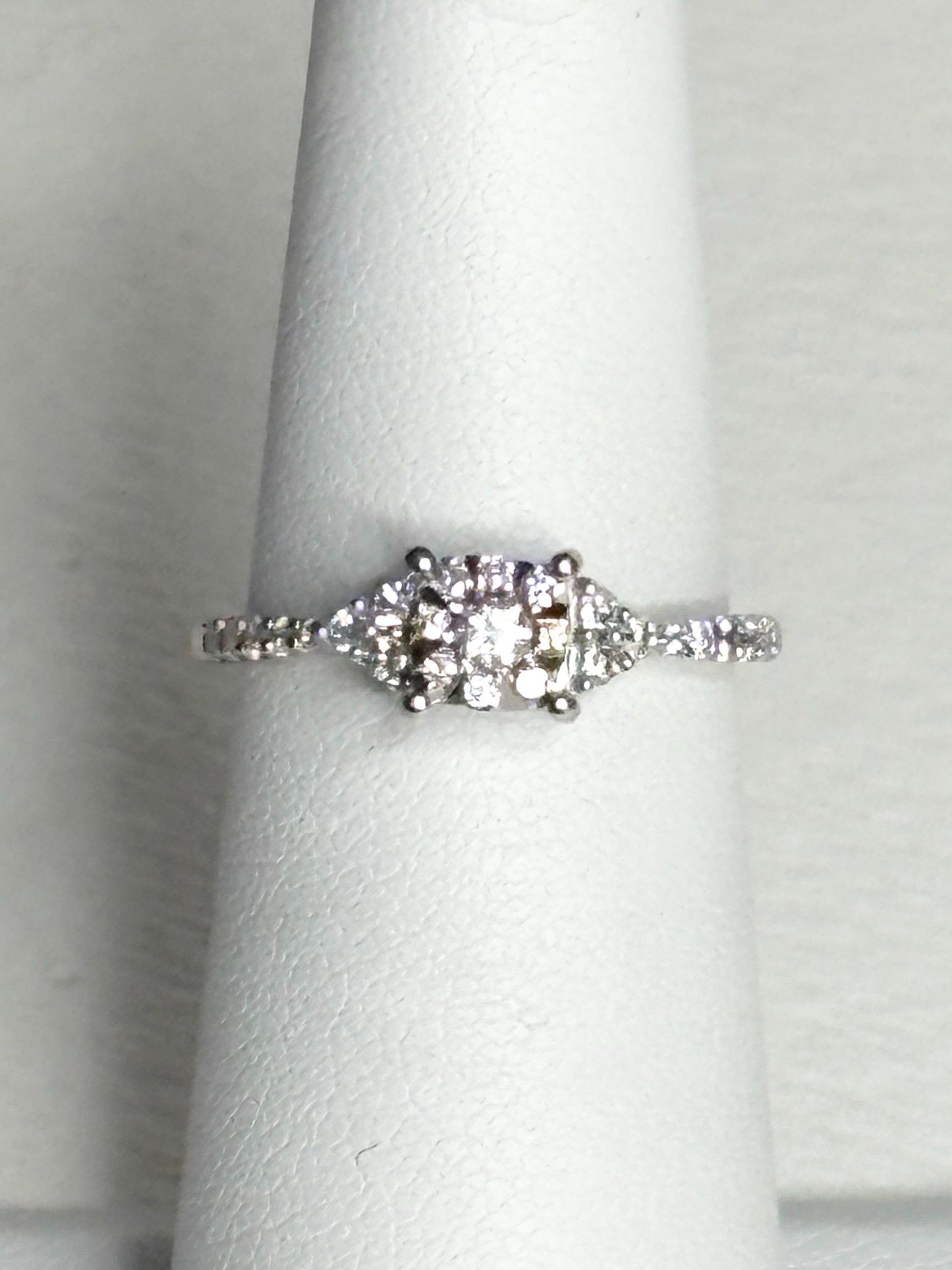 A 14k white gold ring with a squared diamond halo cluster.