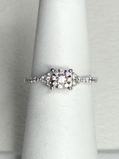 A 14k white gold ring with a squared diamond halo cluster.