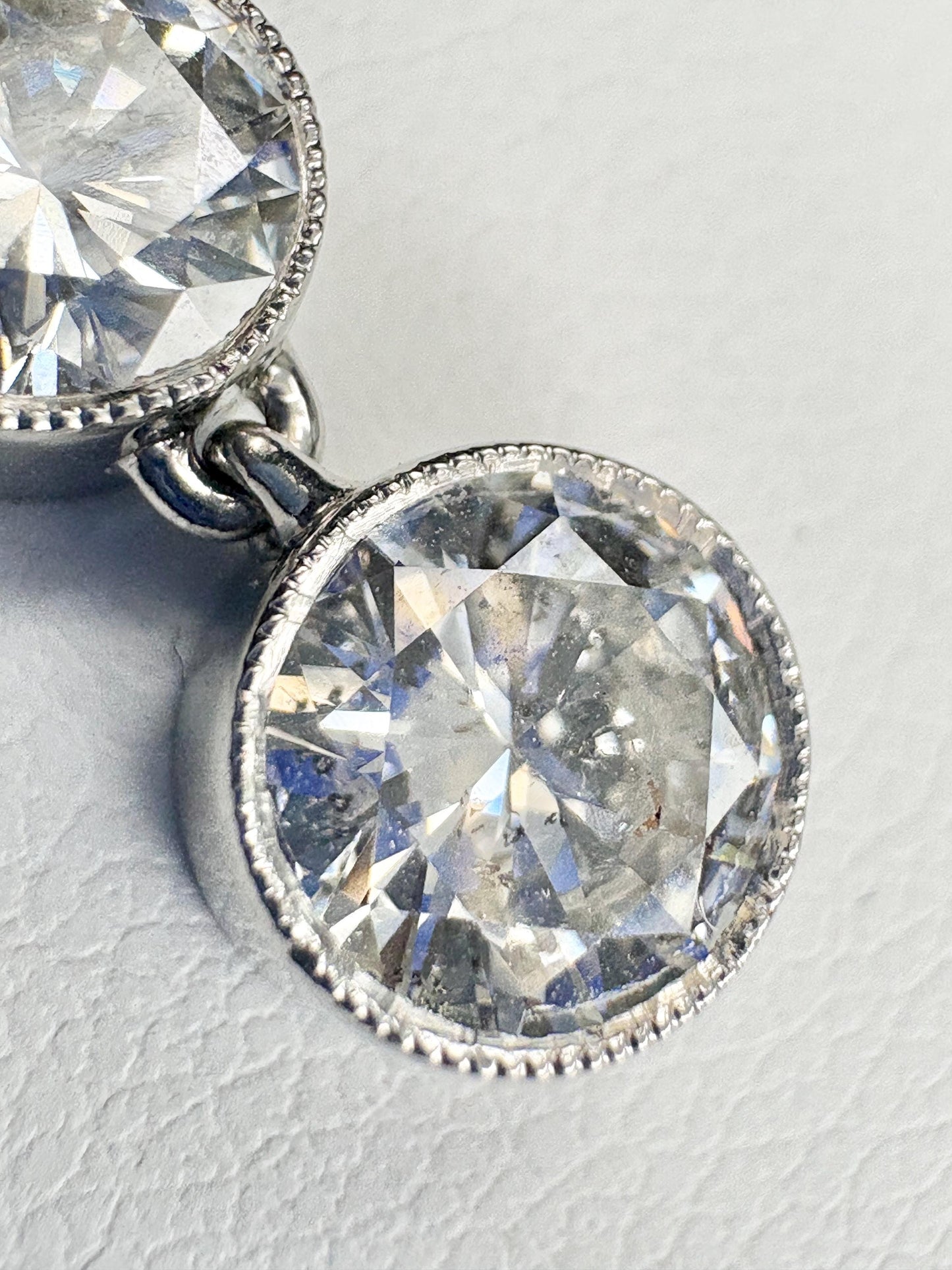 A 14k white gold necklace with two bezel-set natural diamonds.