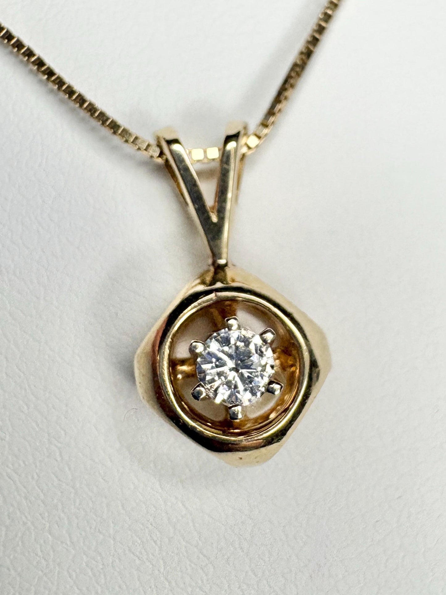 Vintage 14k gold pendant necklace with a round diamond on a box chain.