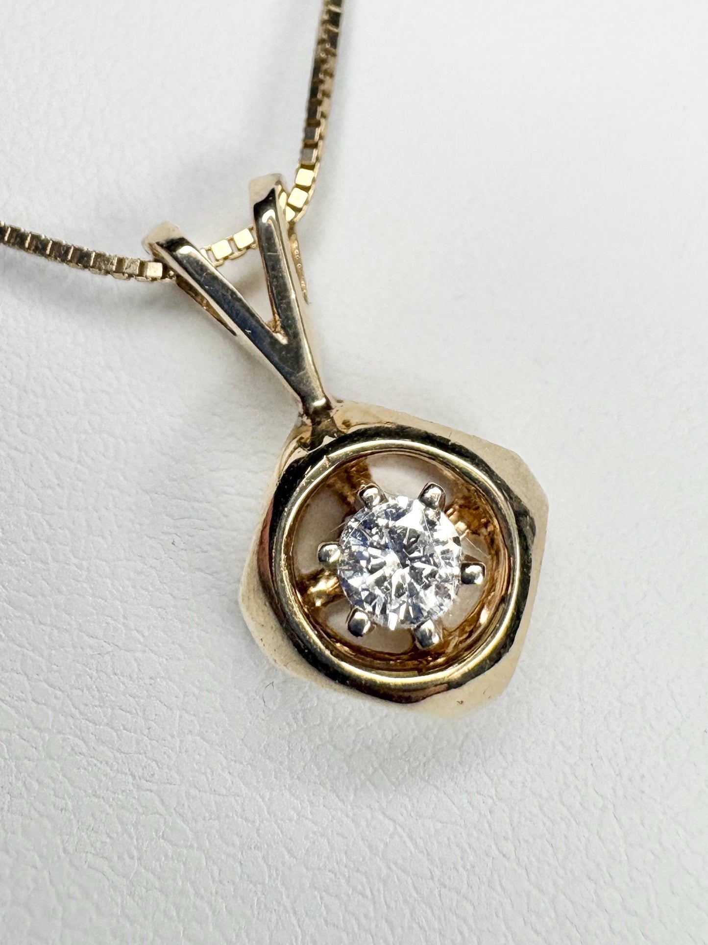 Vintage 14k gold pendant necklace with a round diamond on a box chain.