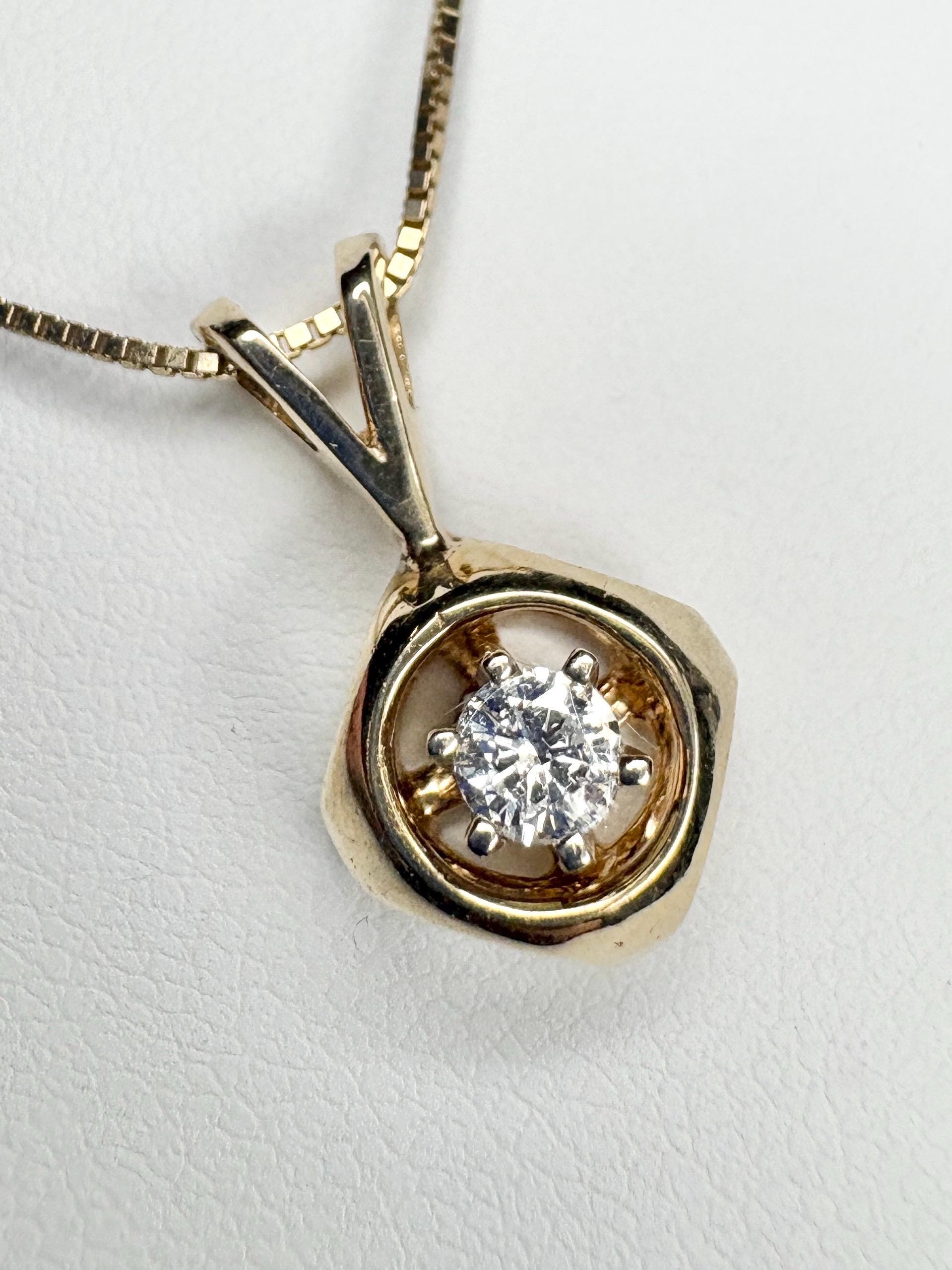 Vintage 14k gold pendant necklace with a round diamond on a box chain.