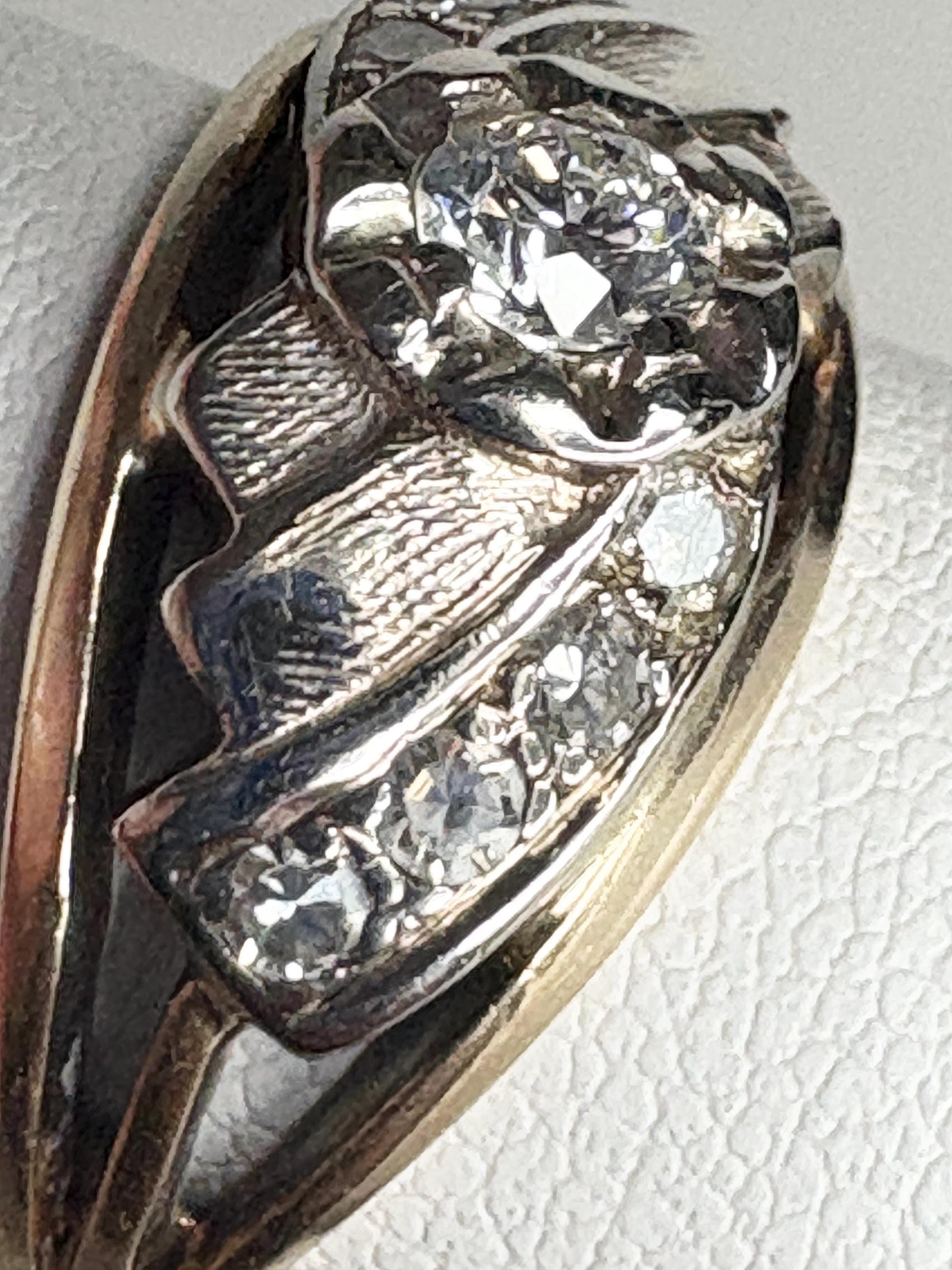 Mid-century two-tone 14k gold ring with diamonds and textured details.
