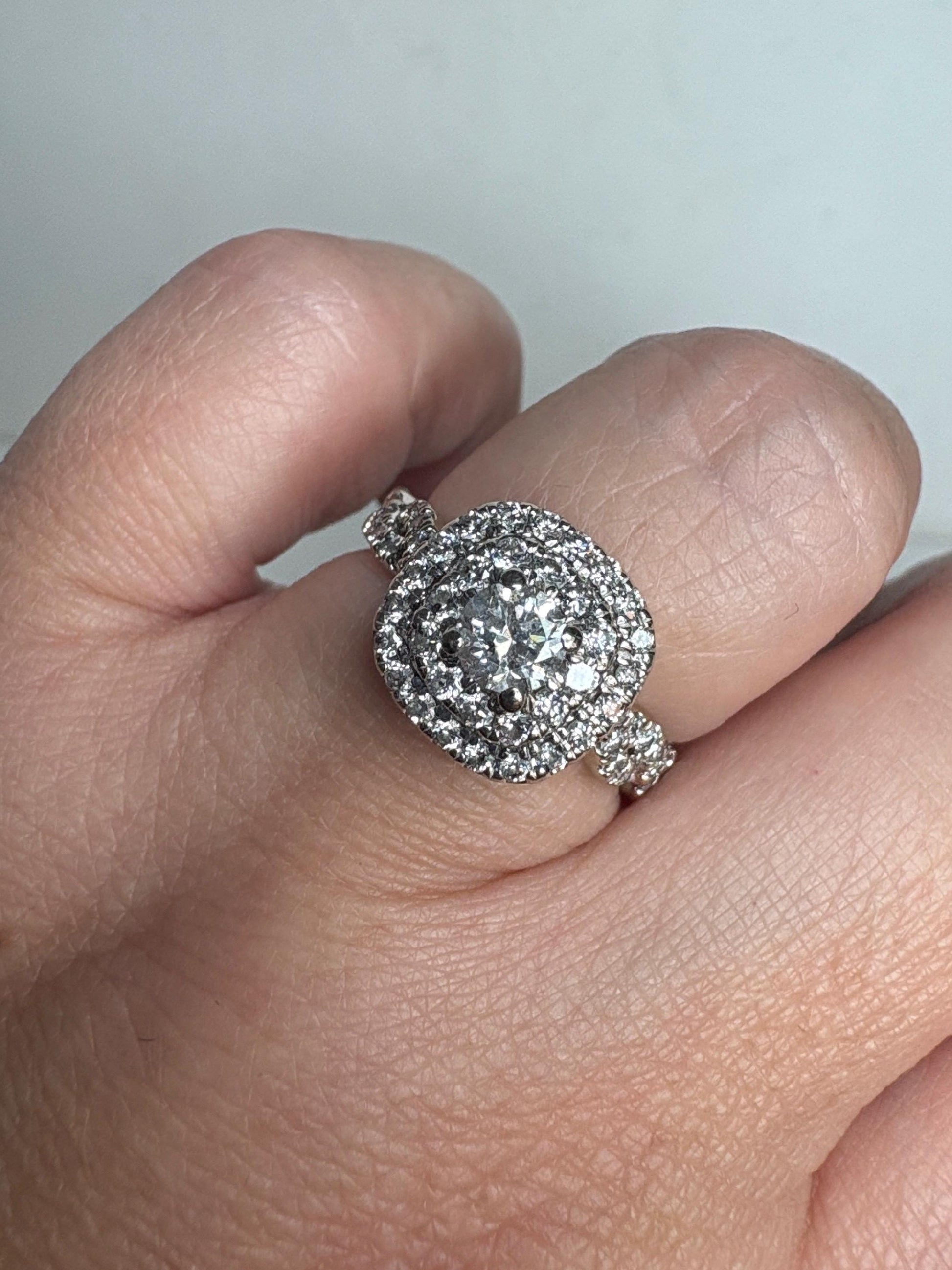 A 1.30ctw natural diamond double halo engagement ring in 14k white gold.