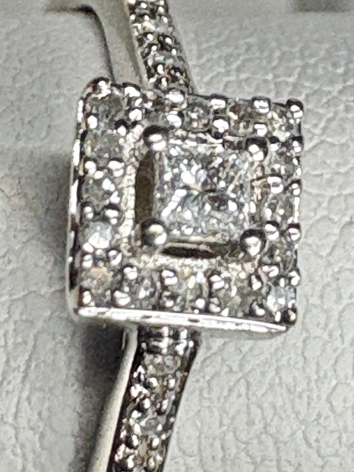 Princess cut diamond halo ring in 10k white gold.