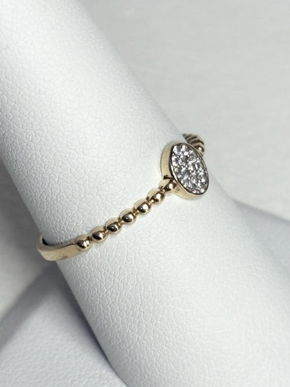 Dainty 14k gold ring with a beaded band and an oval pave-set crystal cluster.