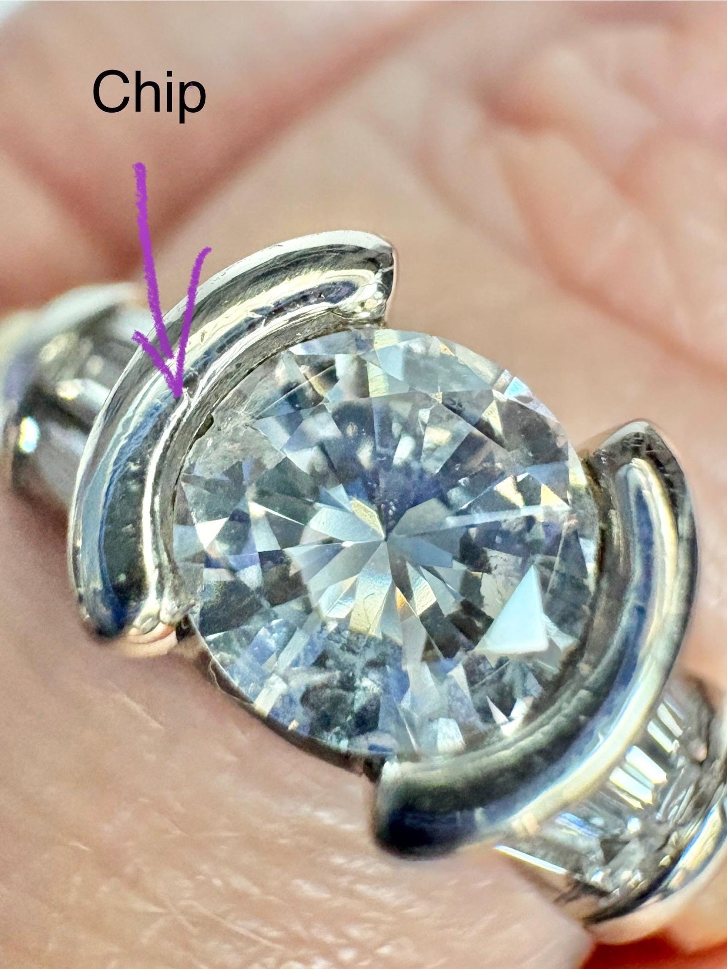 A two-tone 14k gold ring with a half-bezel set diamond and channel-set baguette diamonds.