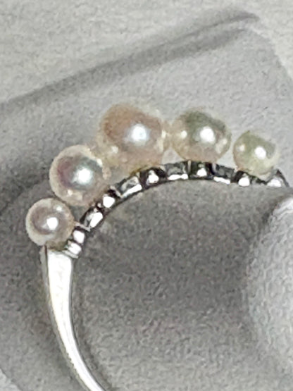 18k white gold band ring with five Japanese Akoya pearls.