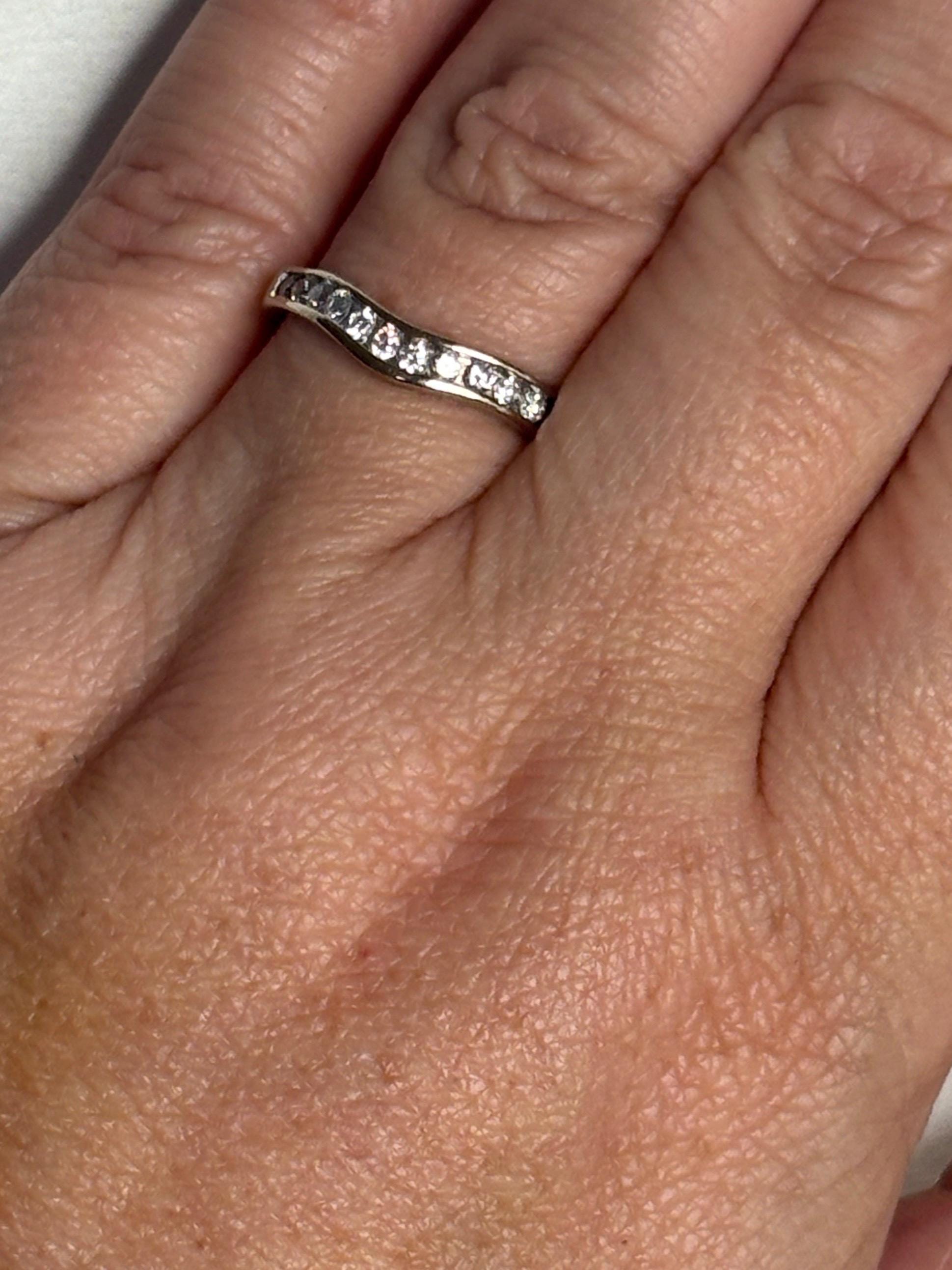 Contoured 14k white gold band with channel-set diamonds.