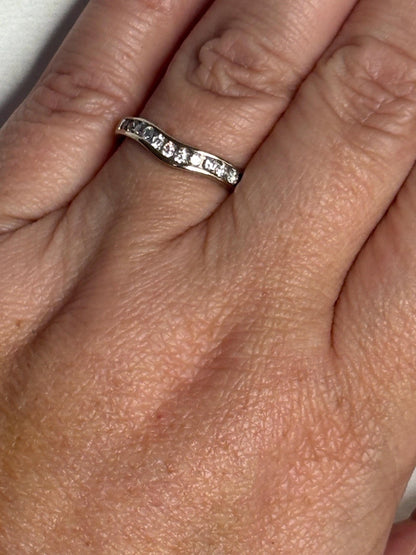 Contoured 14k white gold band with channel-set diamonds.