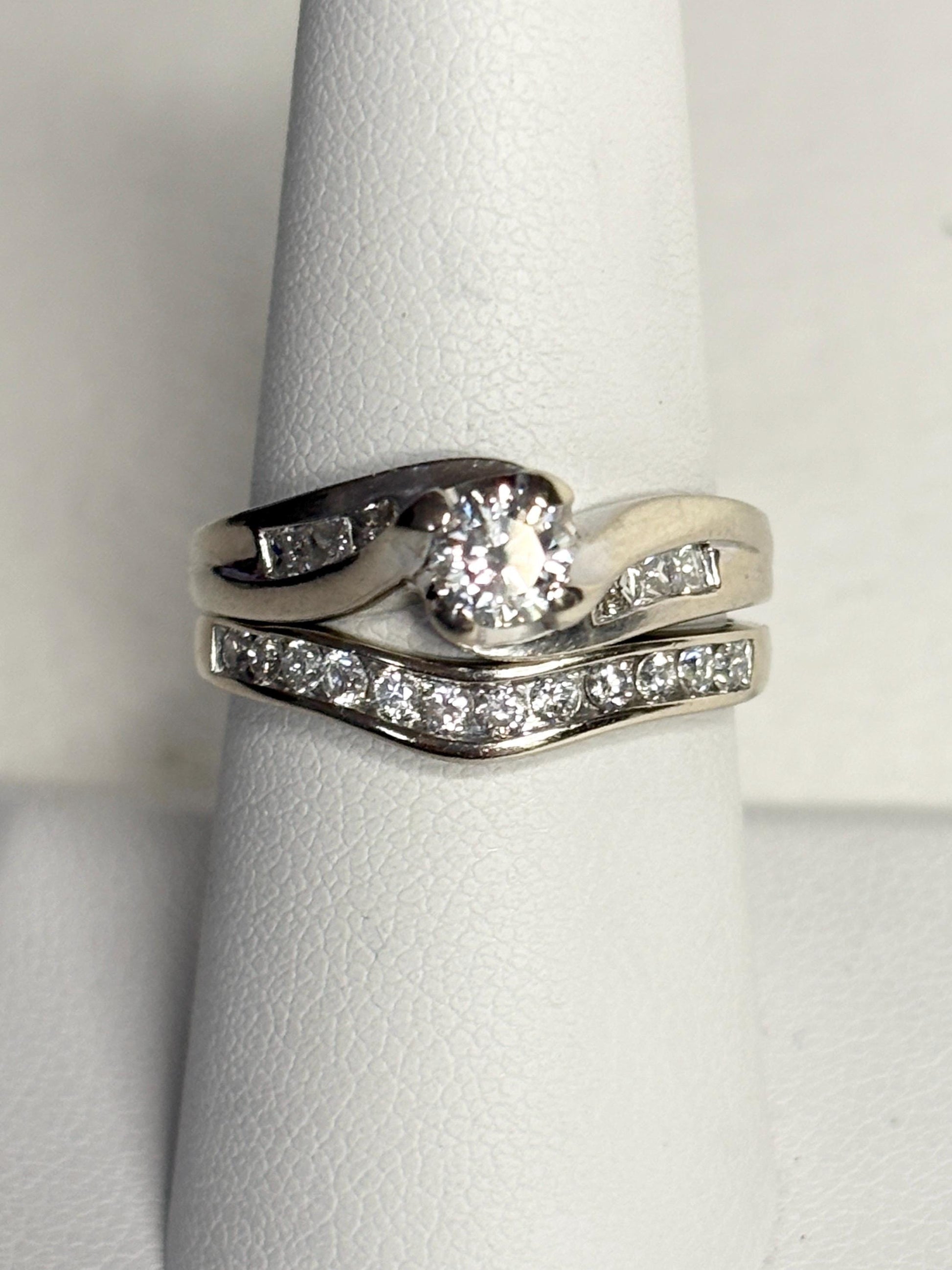 Contoured 14k white gold wedding band with channel-set diamonds.