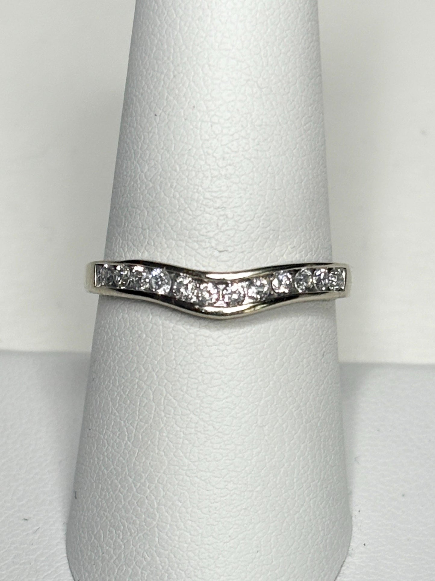 Contoured 14k white gold band with channel-set diamonds.