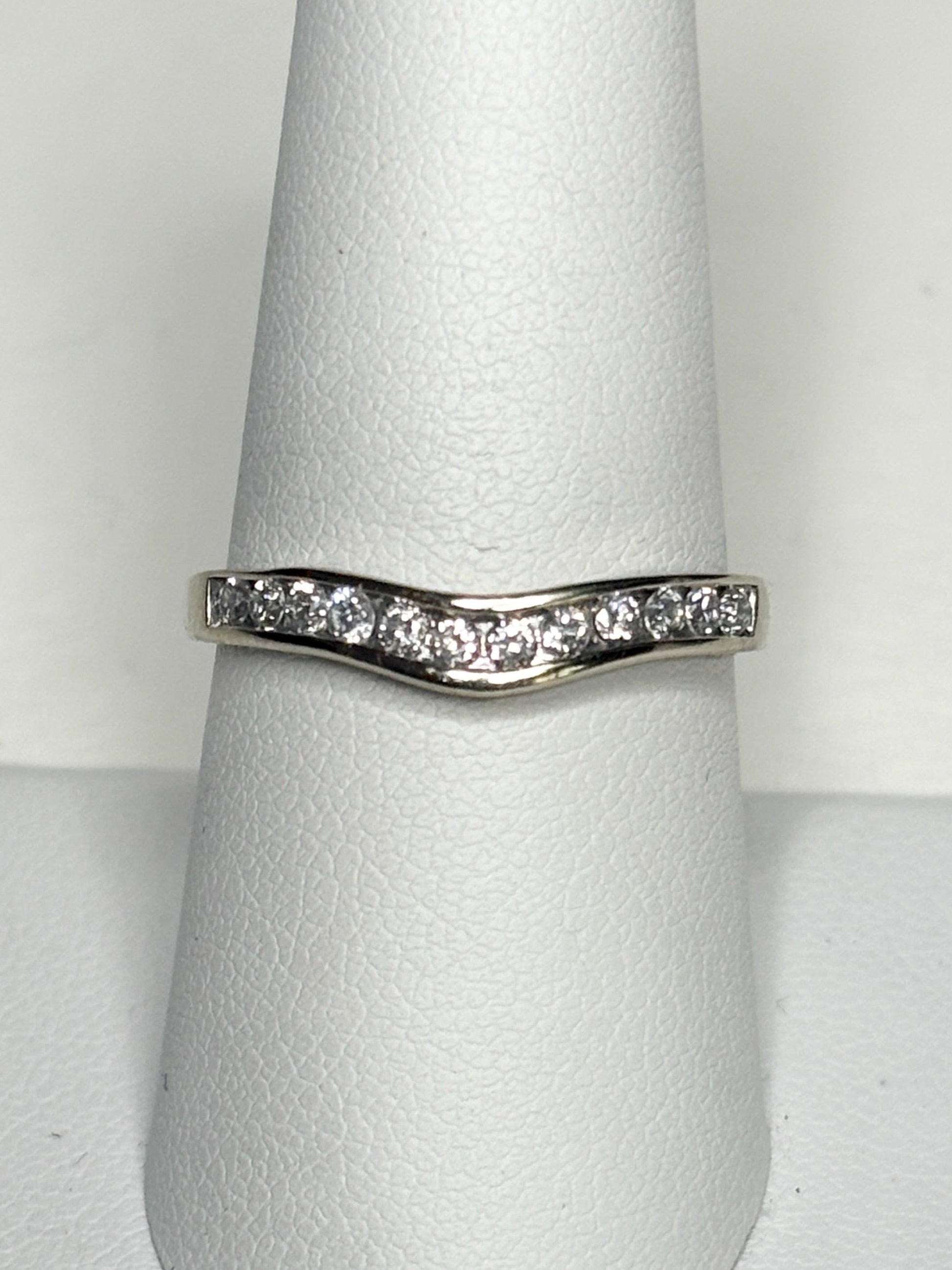 Contoured 14k white gold band with channel-set diamonds.