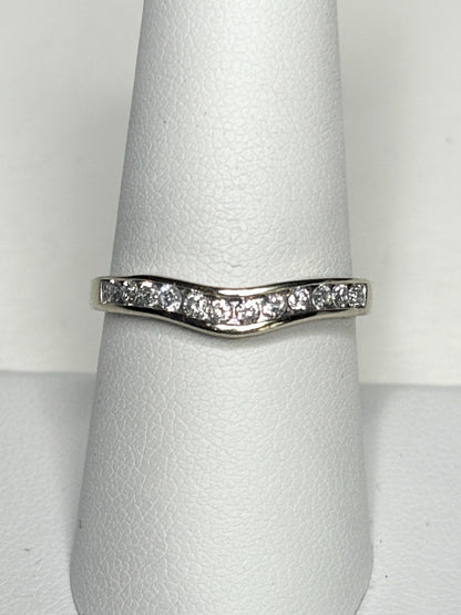 Contoured 14k white gold band with channel-set diamonds.